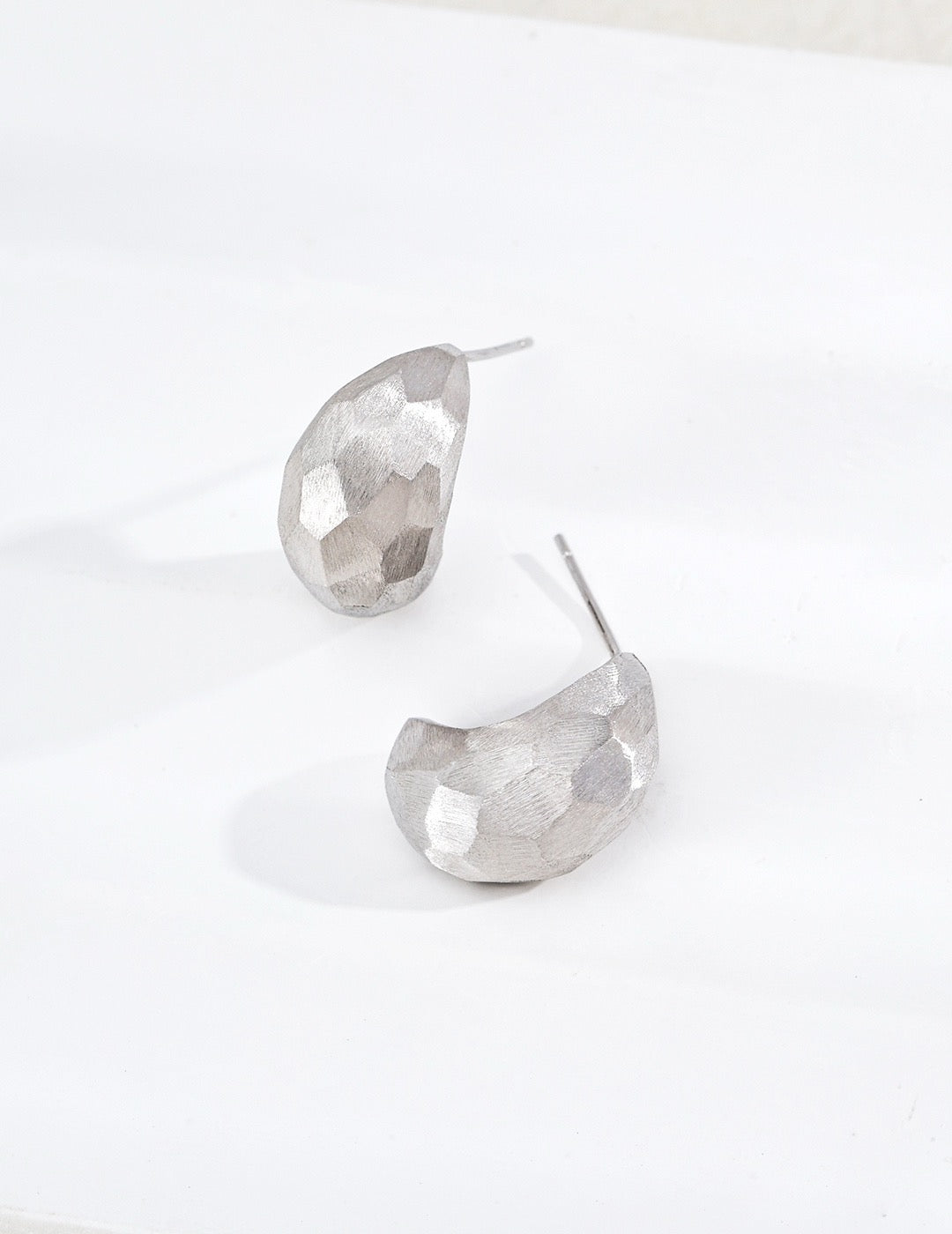Sterling silver earrings with faceted cuts and hand‑filed textures, delivering bold architectural‑sculptural vibes.